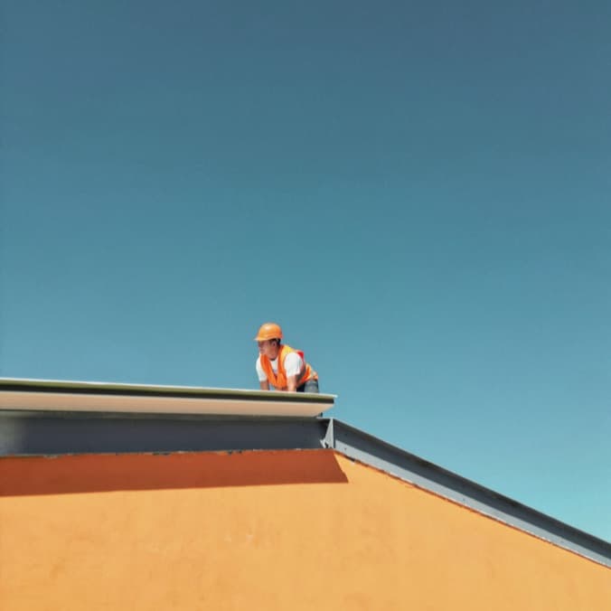 A roofer working on a home