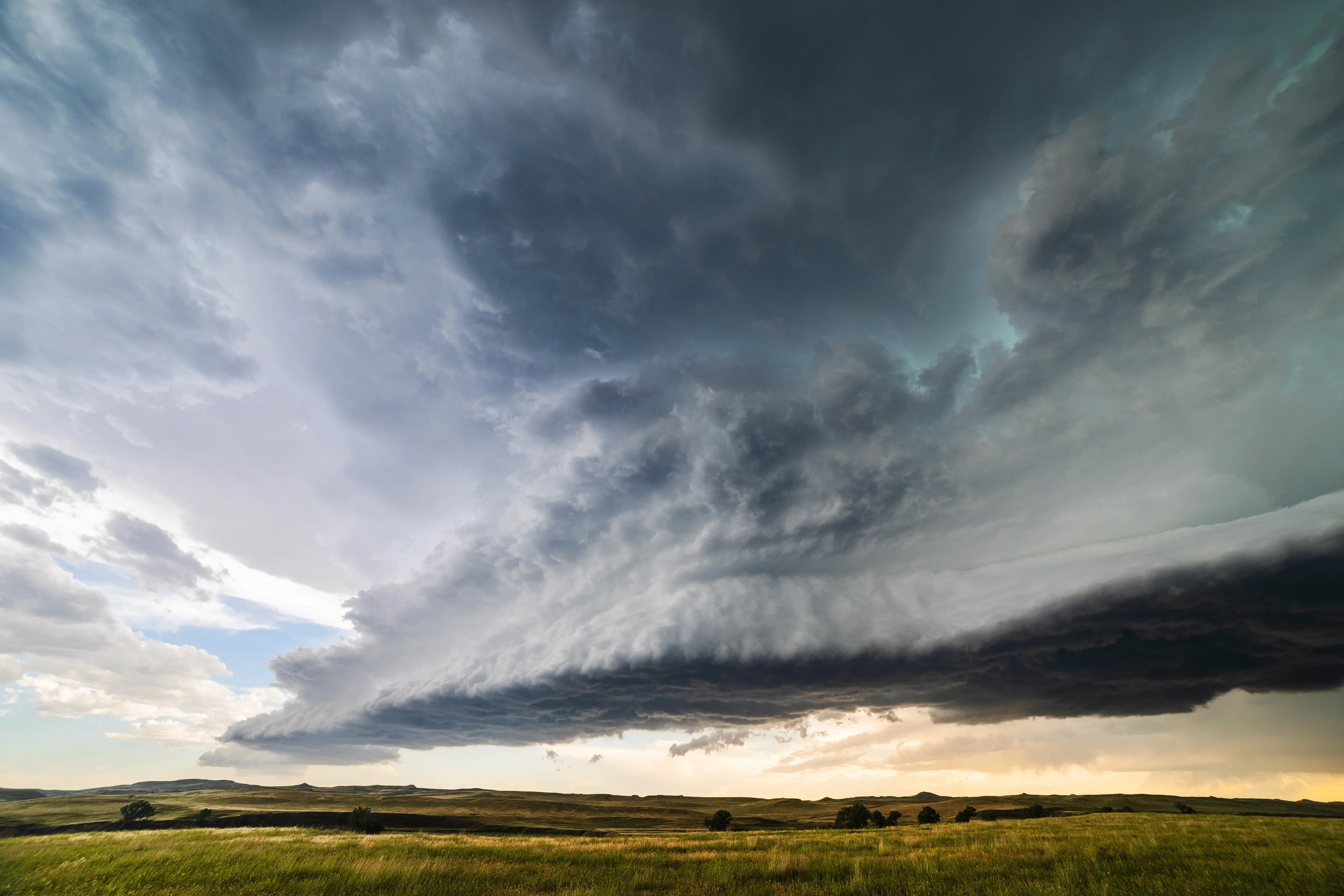 An angular derecho storm speeds across a broad plain in Iowa