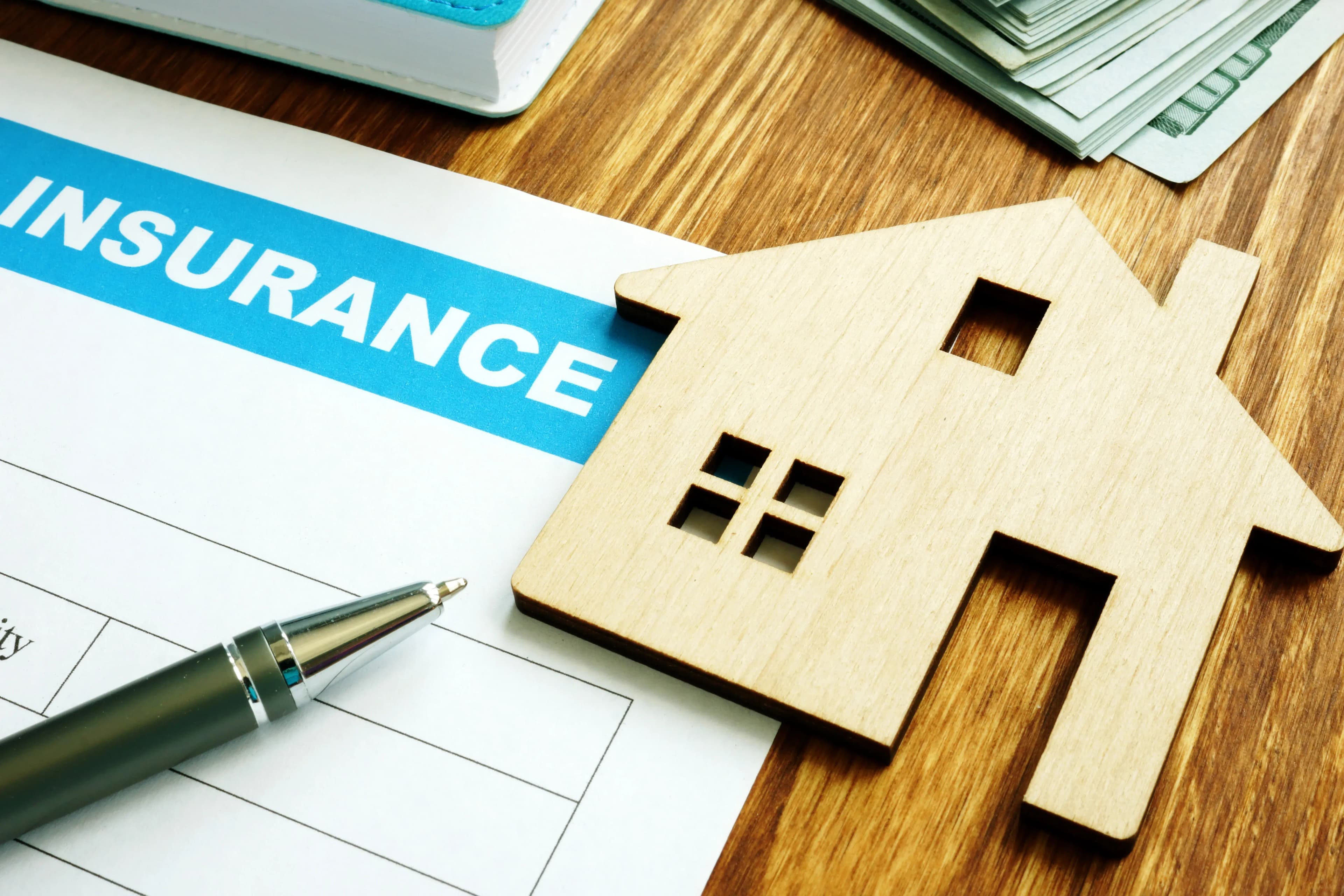 A home insurance policy including wind and hail coverage ready to sign on a desk.