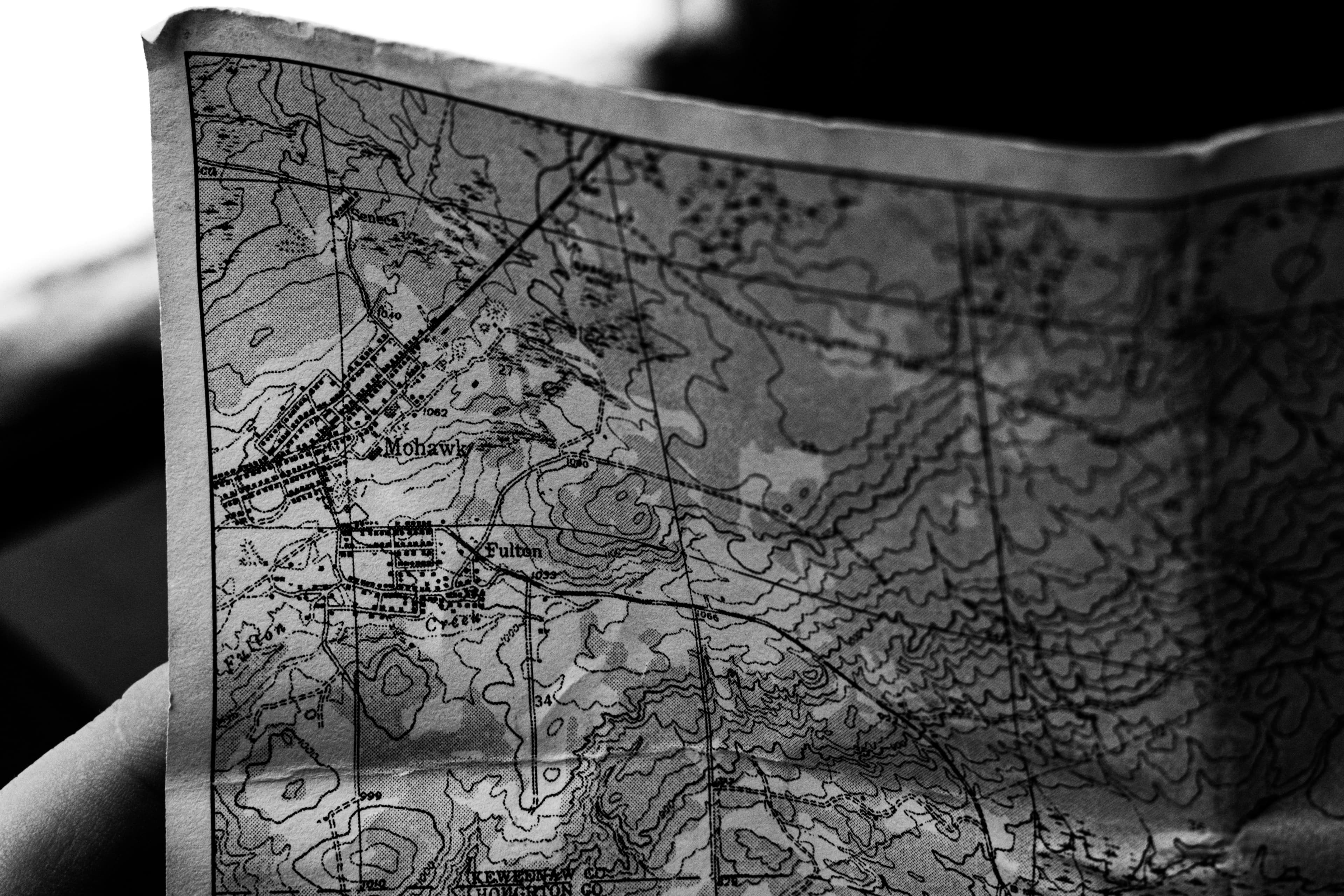A partial view of a paper map of the United States, including some topographical and weather information