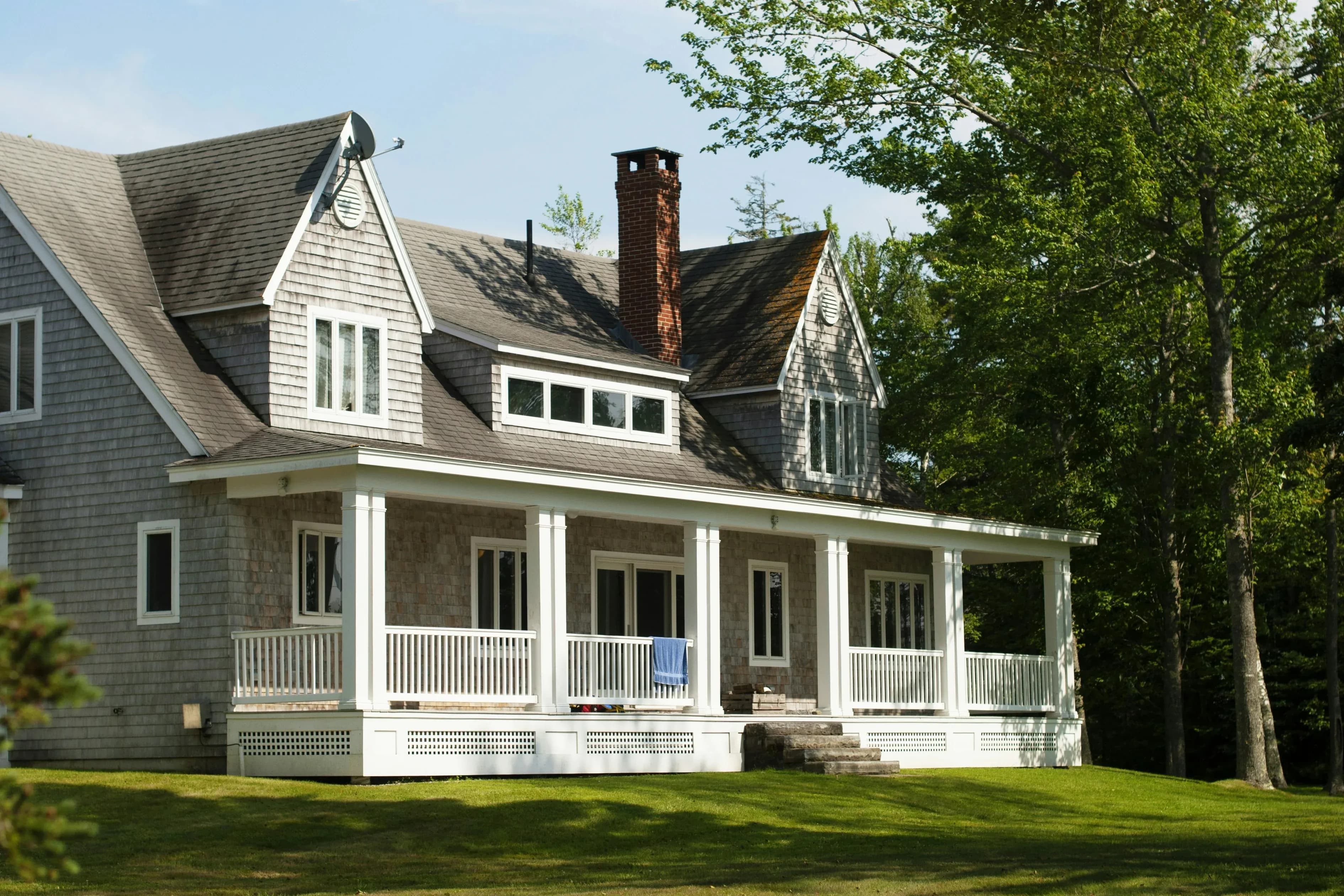 A well-maintained two-story home with a spacious covered front porch.