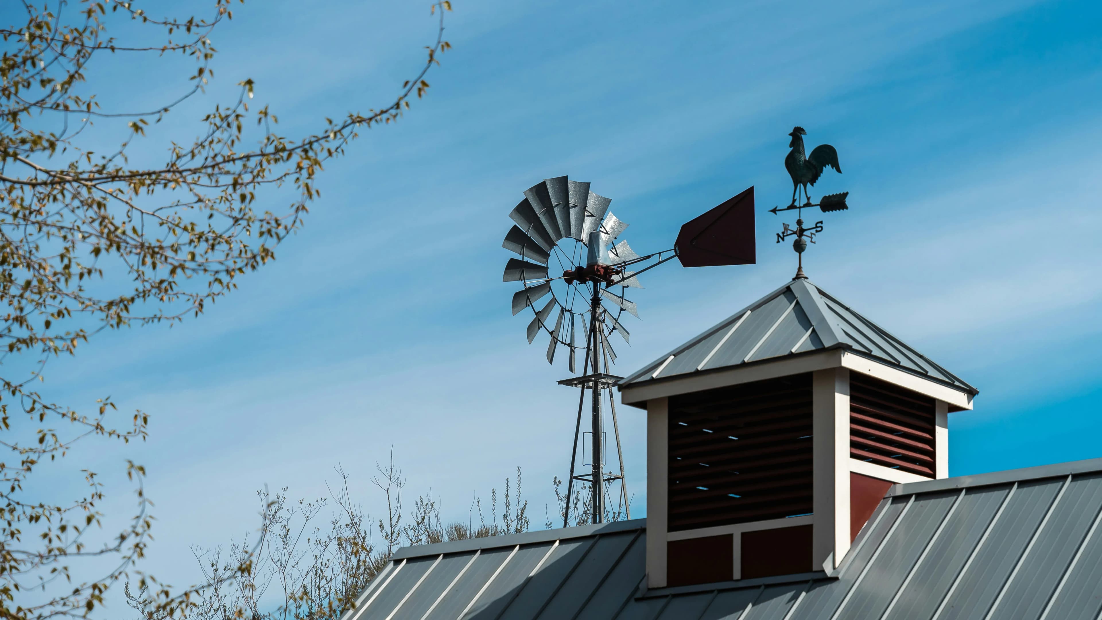 A weathervane on top of a house, indicates the direction of the wind from a windstorm.